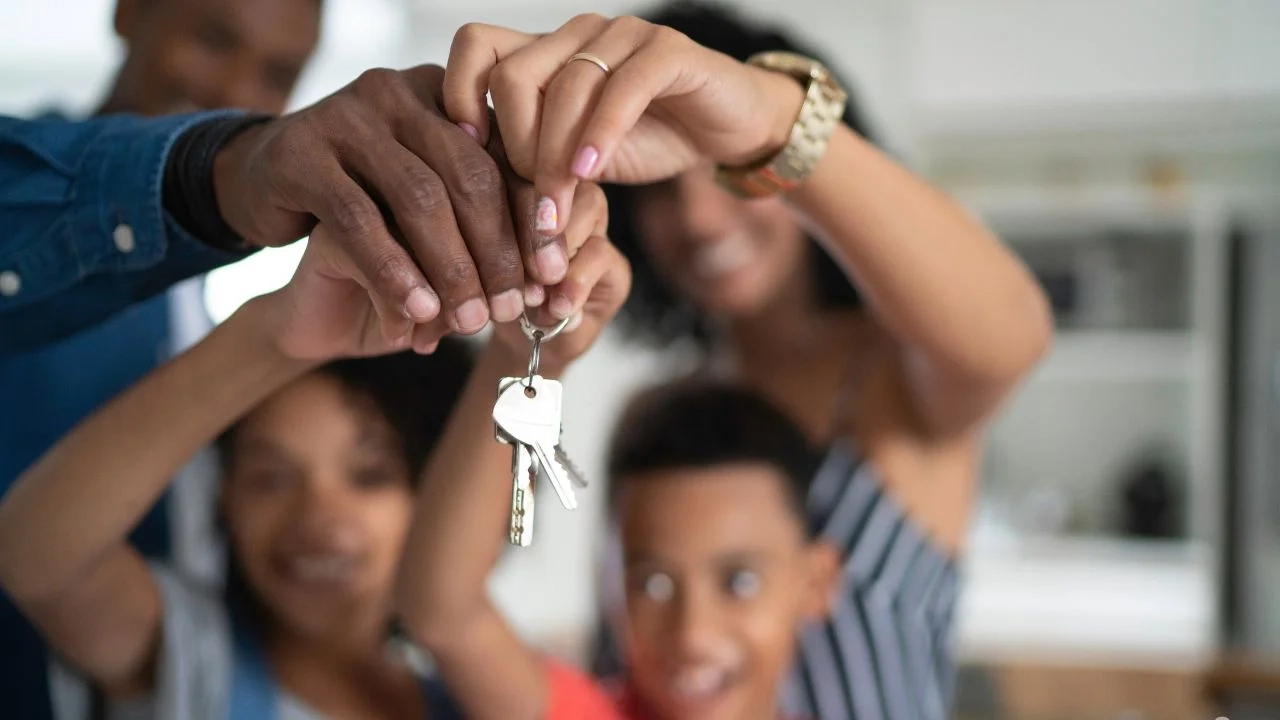 Família feliz segurando chaves de nova moradia